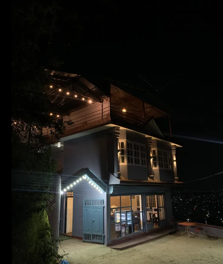 Skyline’s building lit with fairy lights against the dark hillside at night