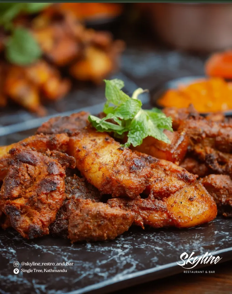 Char-grilled tandoori-style chicken plated with fresh mint