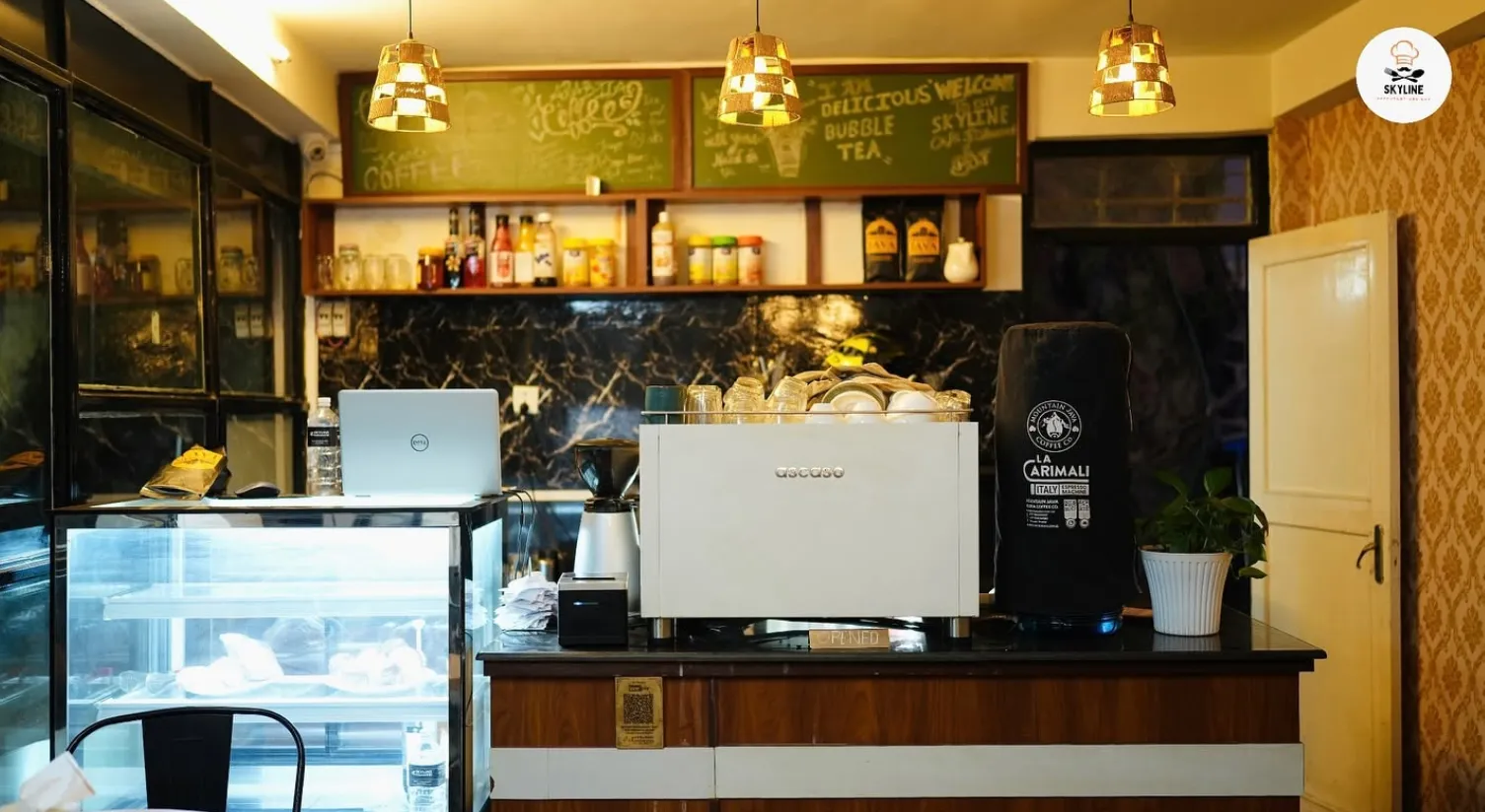 The indoor counter and bar at Skyline with a coffee machine and chalkboard menu