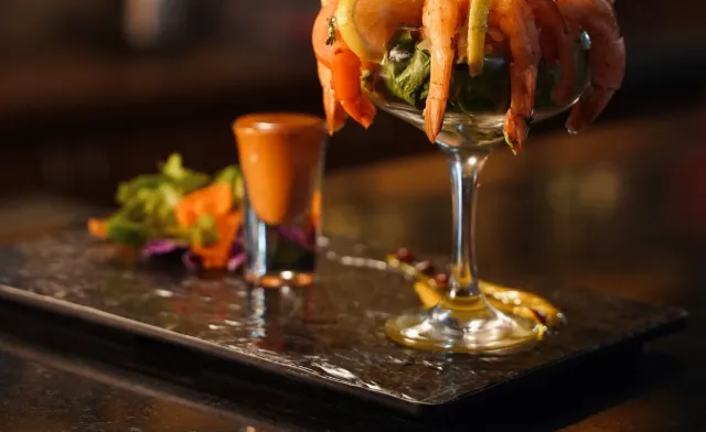 Classic prawn cocktail served in a tall glass at the bar